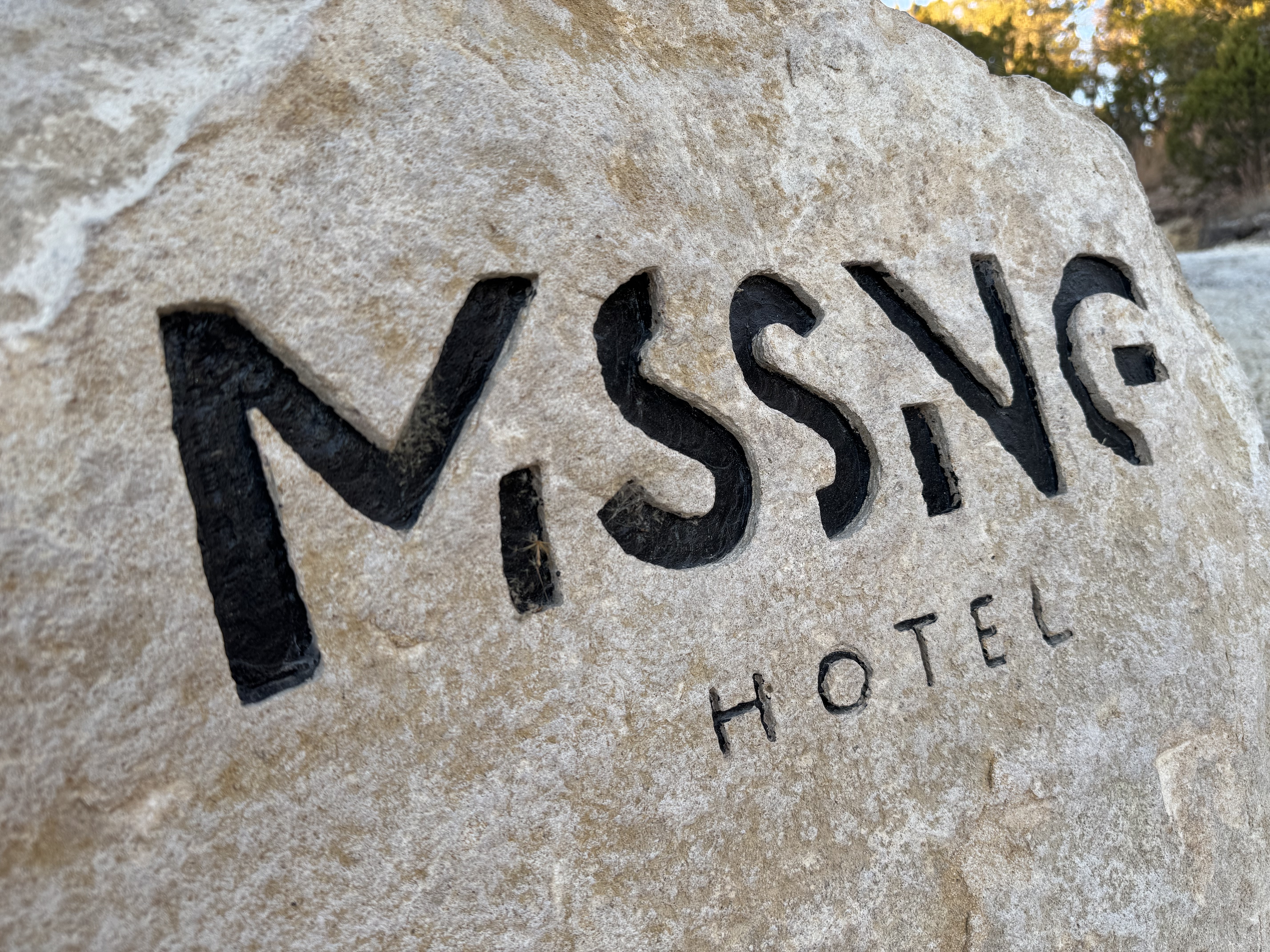 Missing Hotel stone wordmark