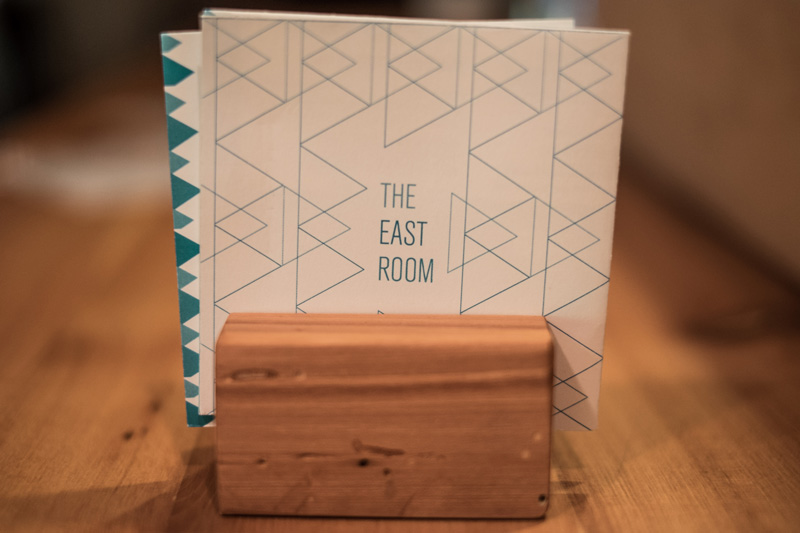 The East Room menu on wood plank tap sign